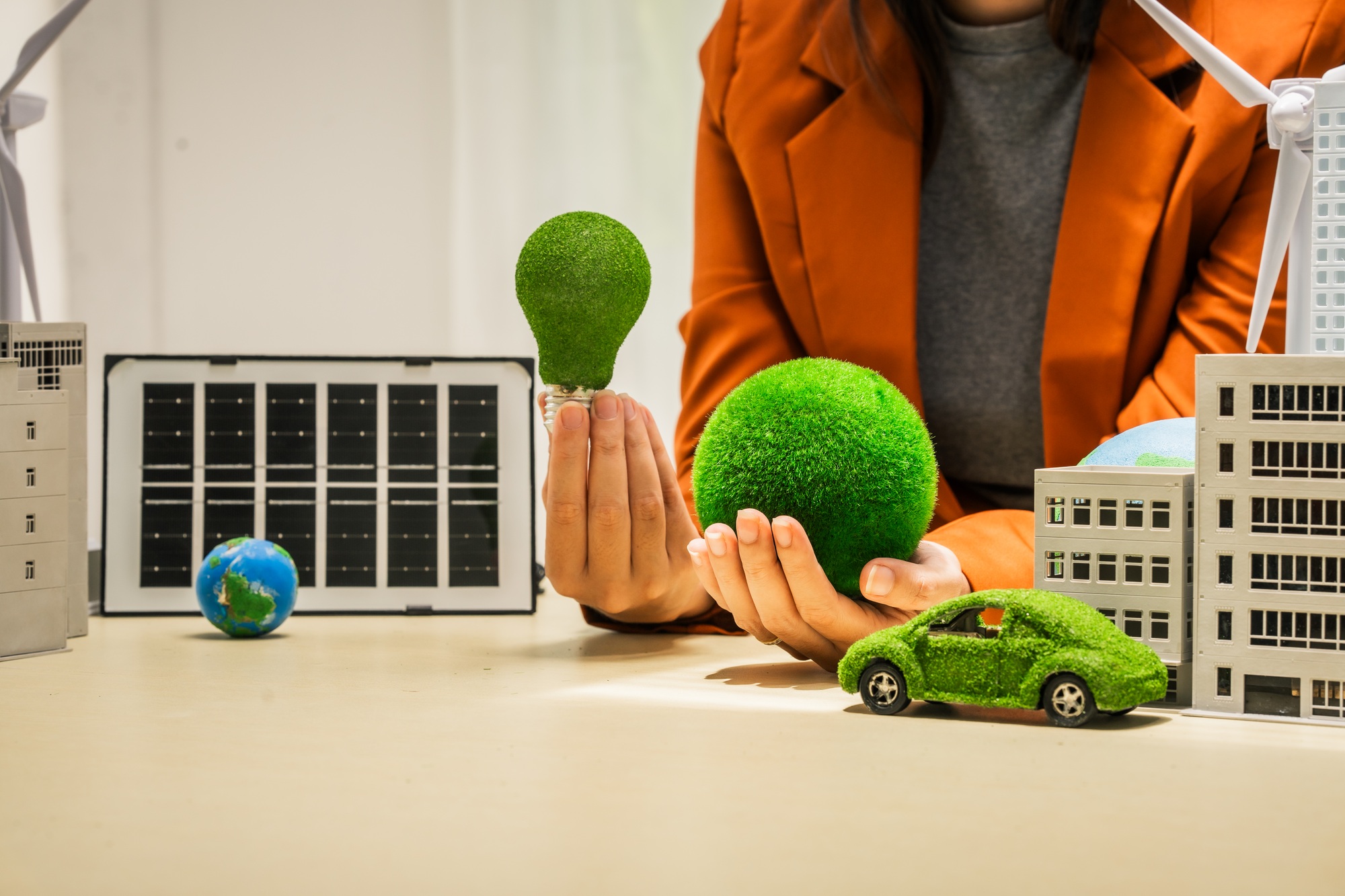 A businesswoman working at a desk in sustainable urban development, promoting eco-friendly