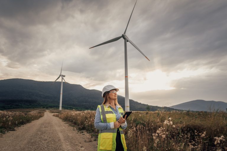 A dedicated female engineer is actively managing wind turbines as part of a significant renewable