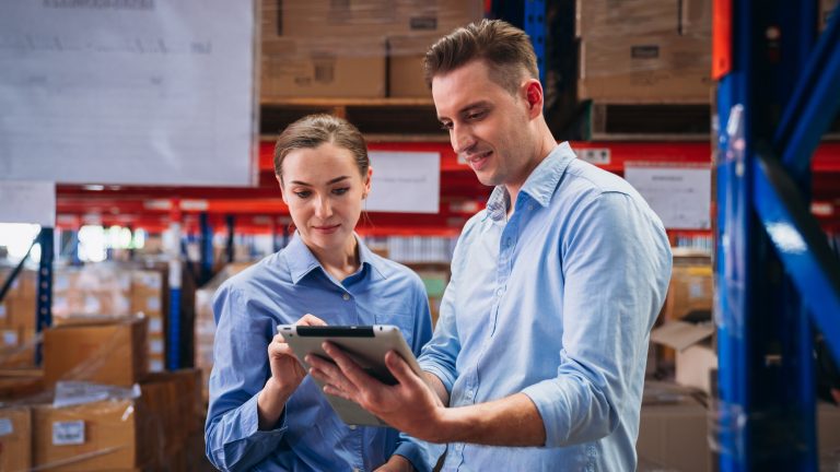 Factory manager using digital tablet check barcode in industry factory logistic.