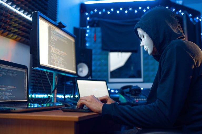 Hacker in mask and hood, account hacking