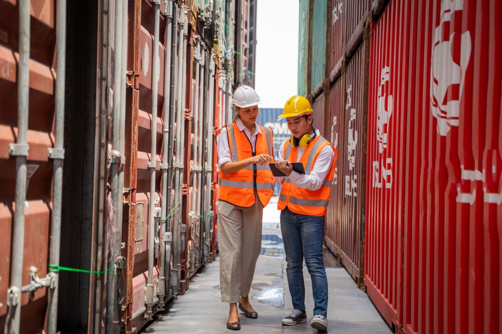 International shipping logistics,Logistics workers of forwarder with tablet inspect cargo.