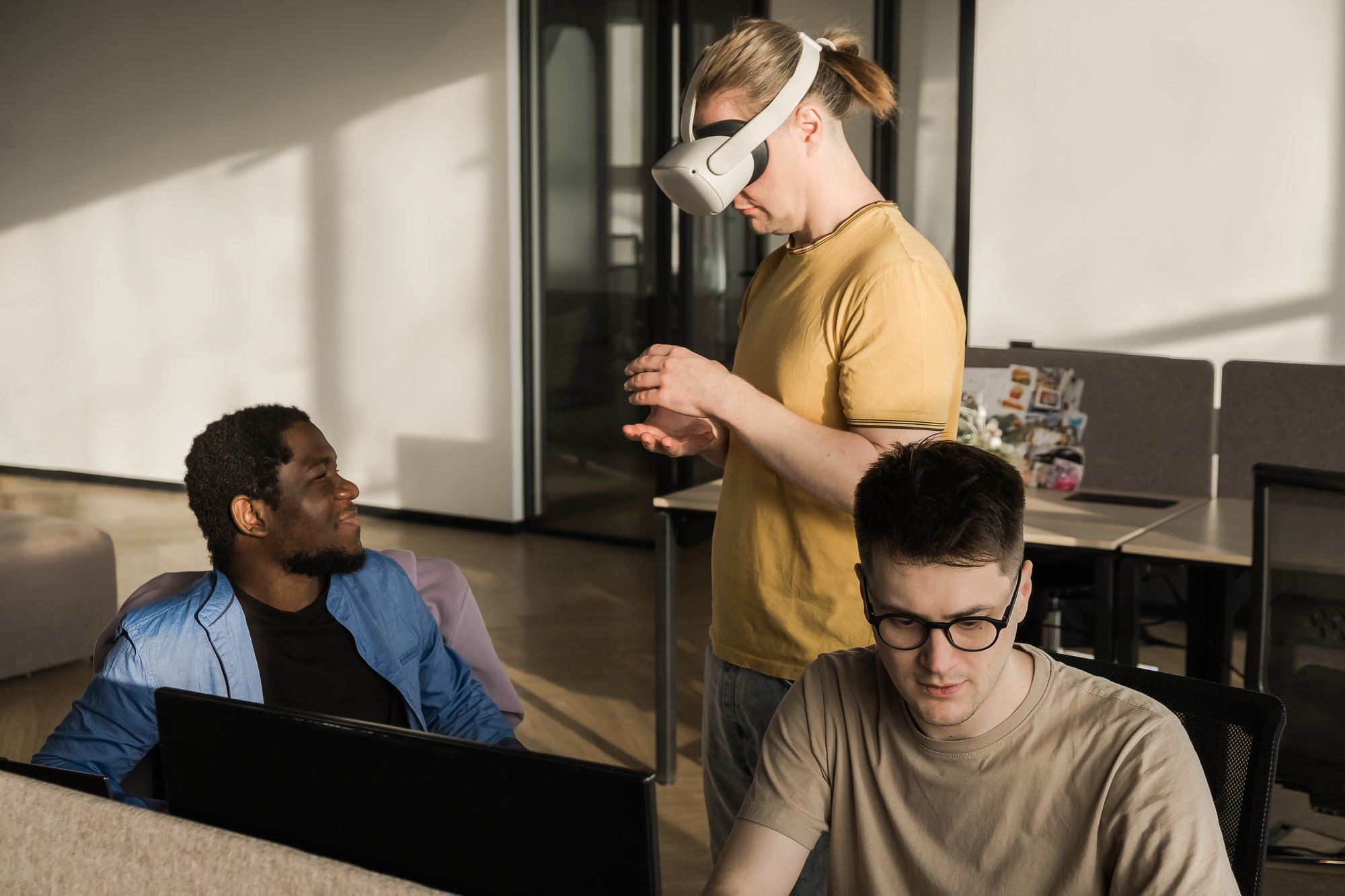 IT Development Team Working on VR Project. Man wearing VR headset, playing and touching something in