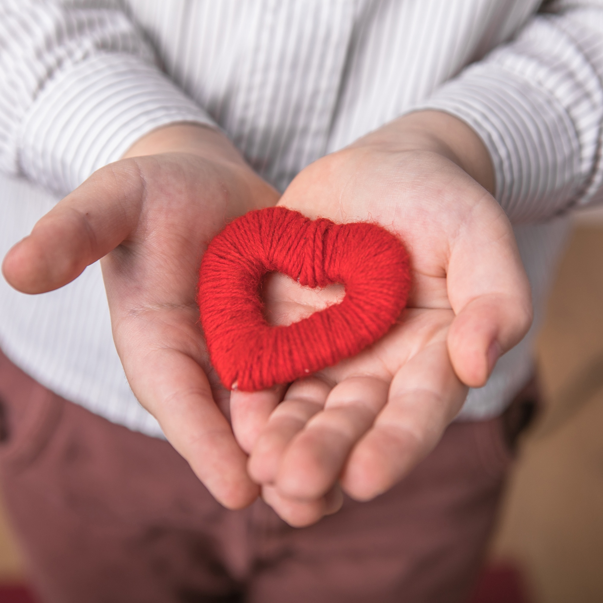 Kid holding a small red heart. Posters about the preservation of the family and children.