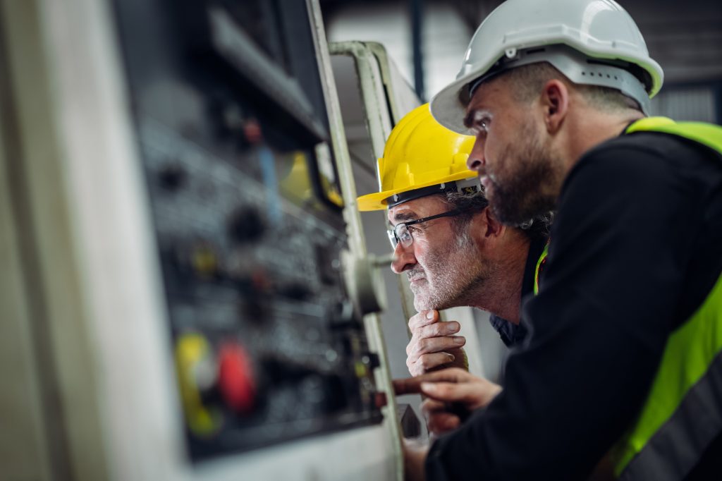 Mechanical Engineering Team Operating Machinery in a Manufacturing Workshop.