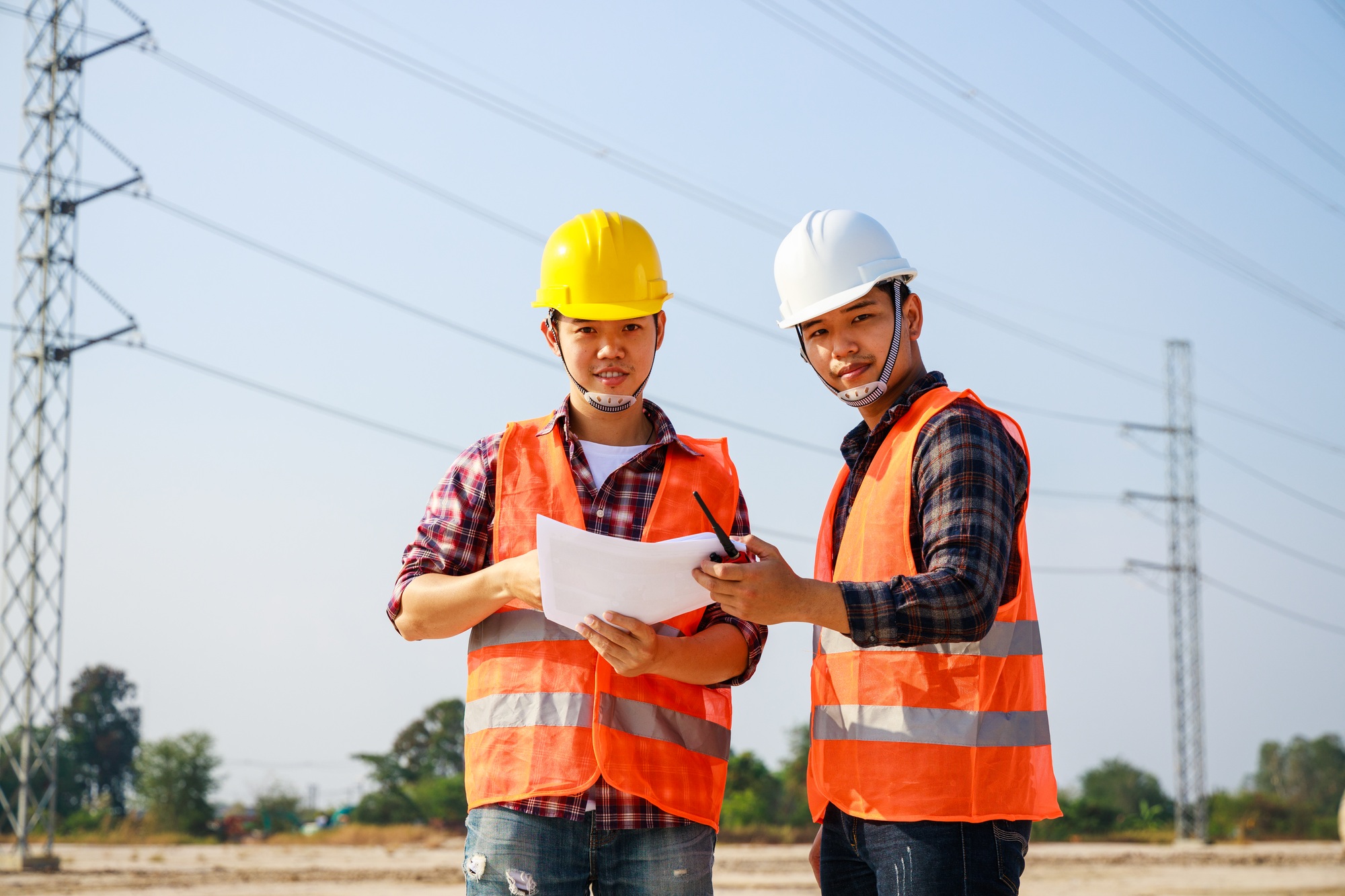 Portrait of Two Engineer, field engineer, foreman, standing in construction Electric power site