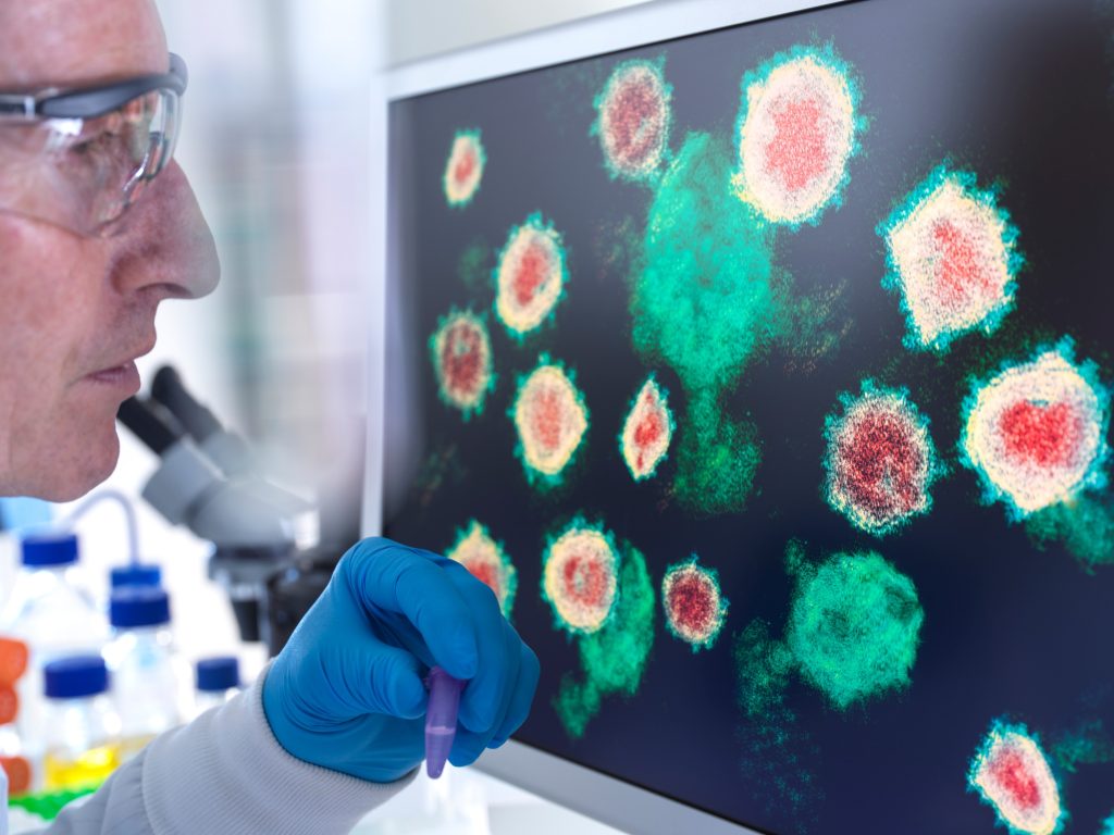Scientist analyzing virus structures on a screen in the lab