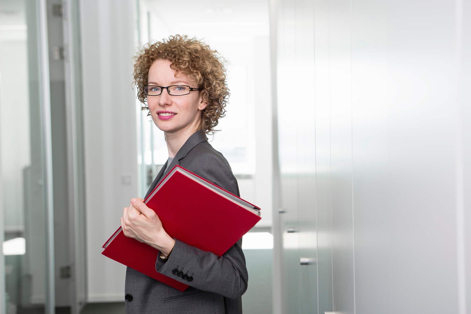 Portrait of businesswoman holding red file