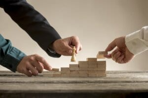 Business teamwork concept with a businessman moving a chess piec