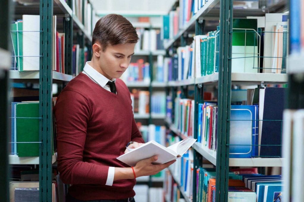 Student searching book in university library