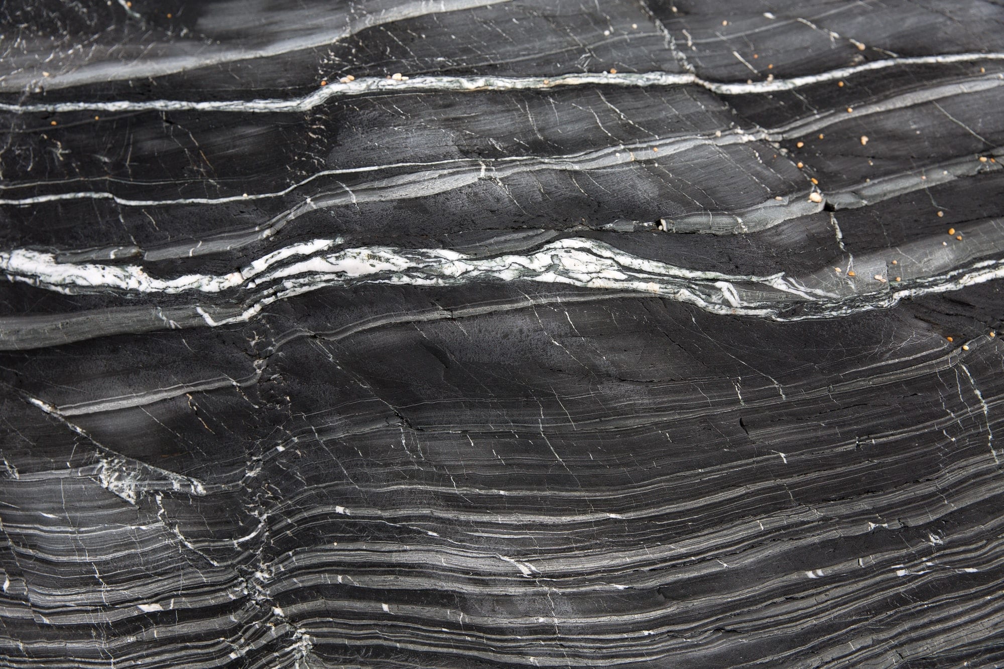 A background image of the layers in a geological rock formation of slate and marble with copy space