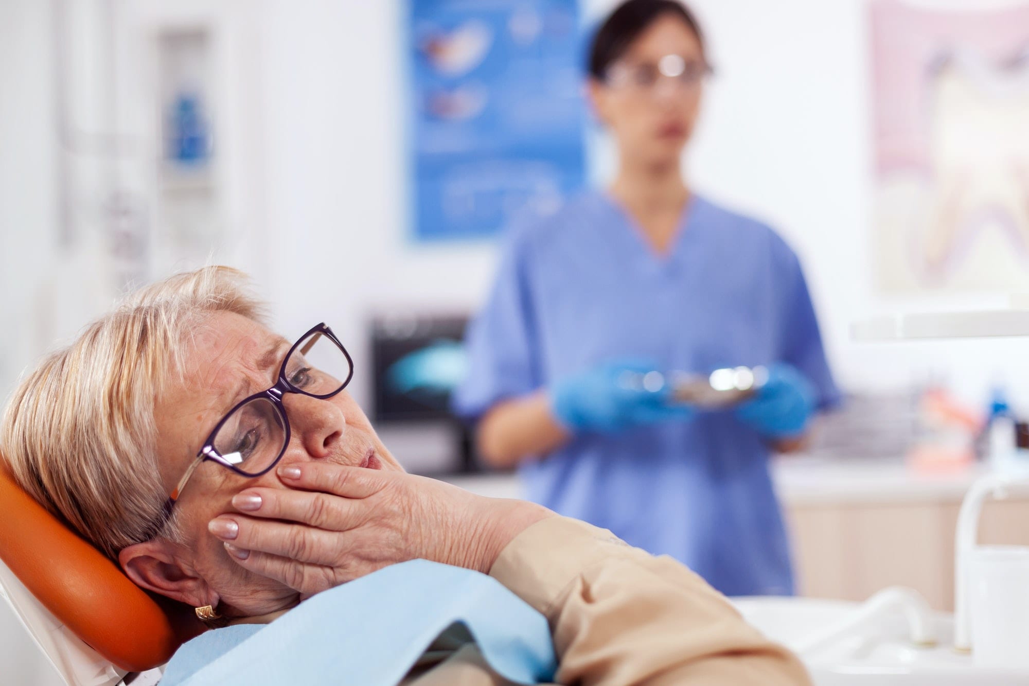Elderly patient in pain at dentist clinic