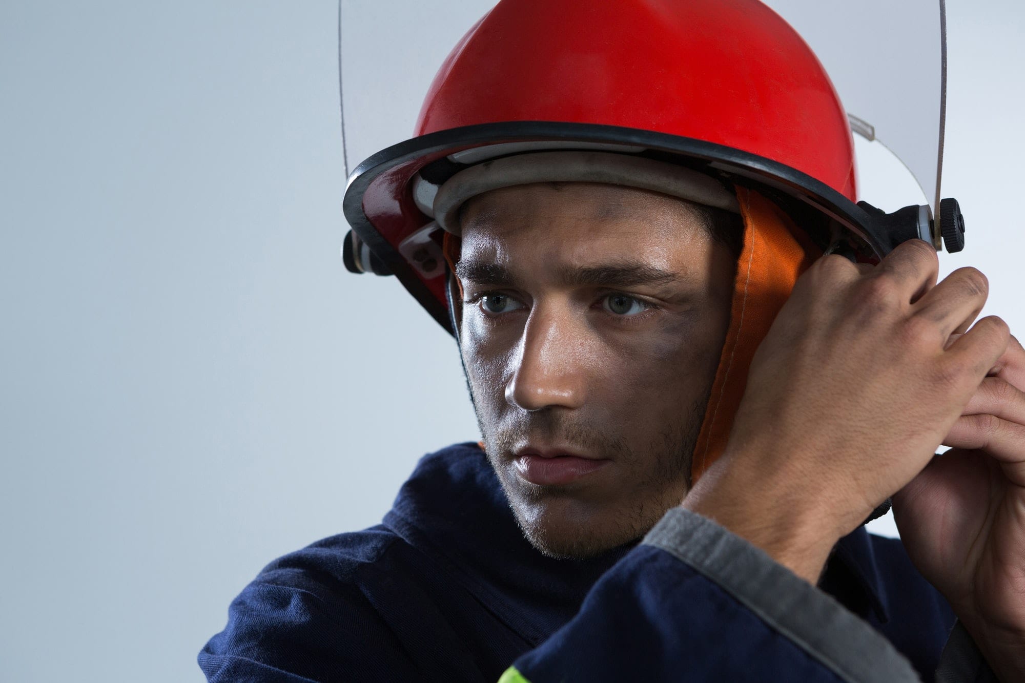 Fireman adjusting his safety helmet