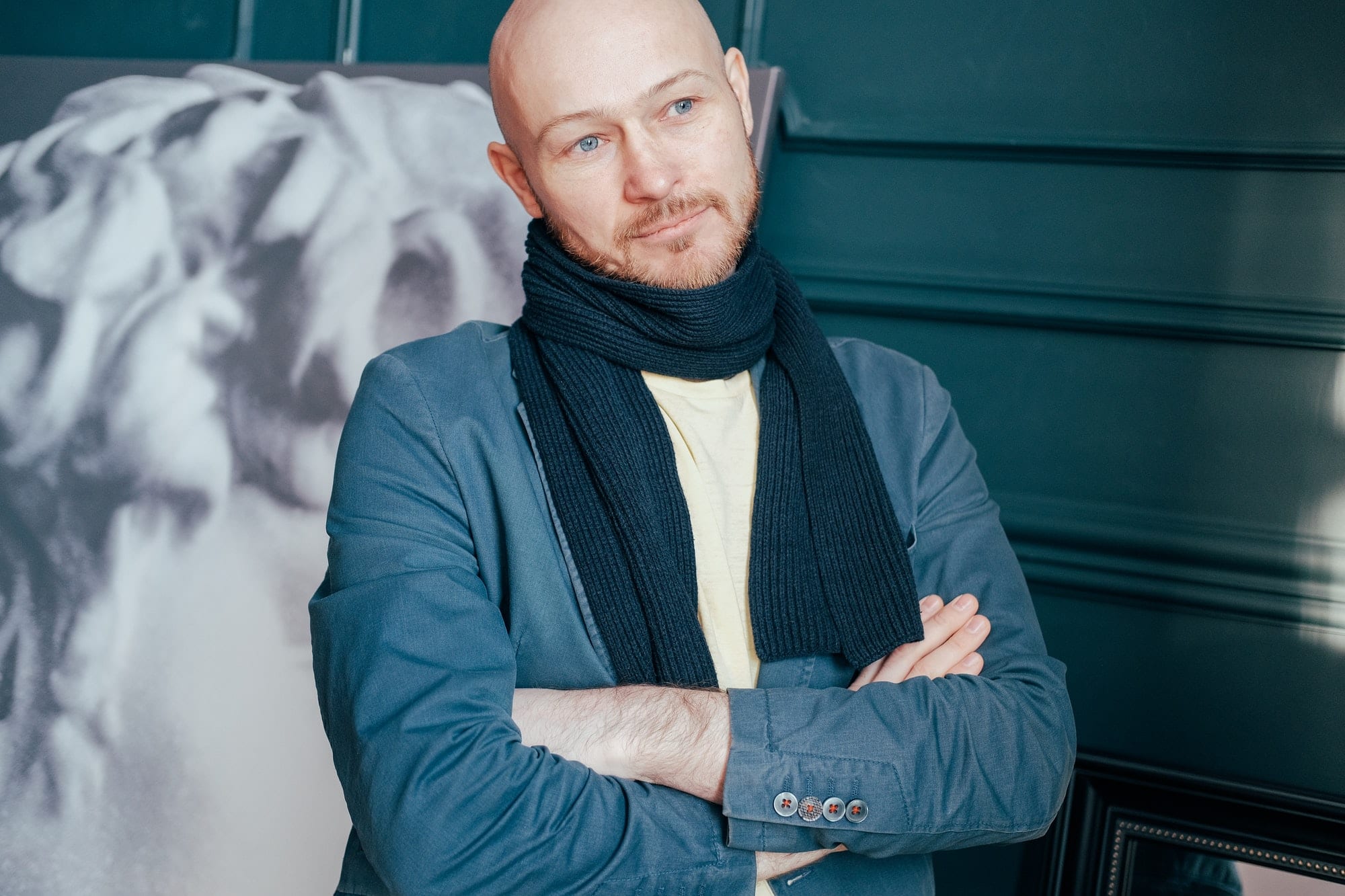 Portrait of attractive adult successful bald man art critic historian with beard in scarf in art