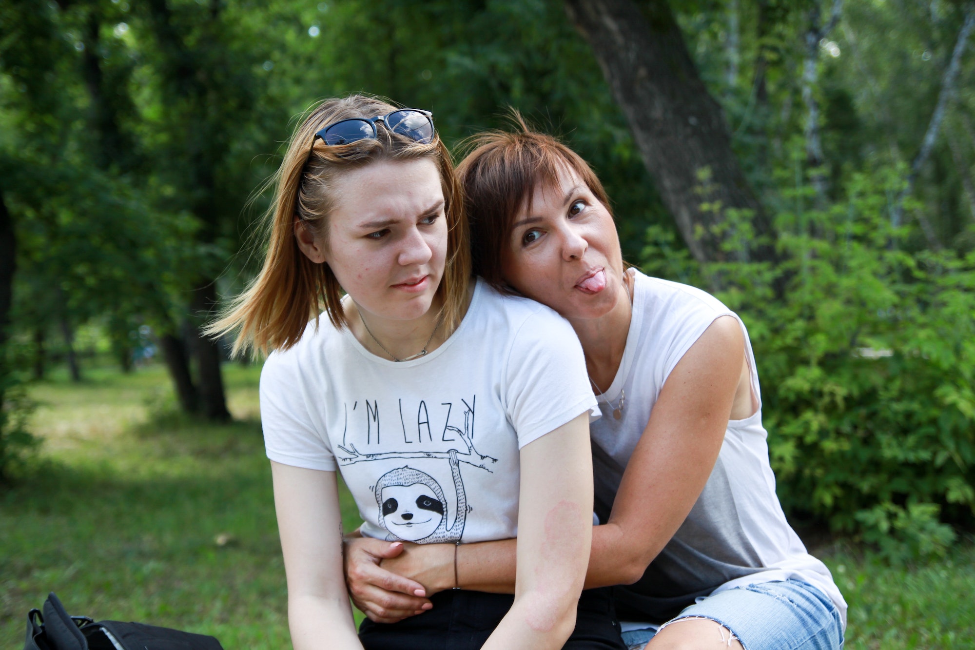 Mum and teenage daughter laughs and making faces. Close relationship